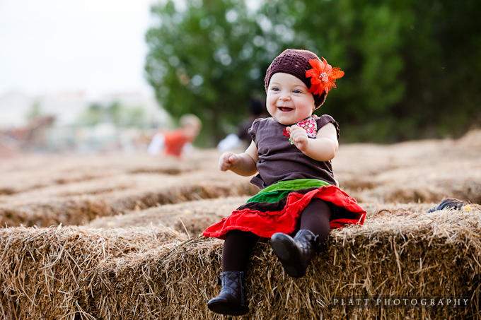 Baby girl, childrens portrait on hay bails in Chandler Arizona