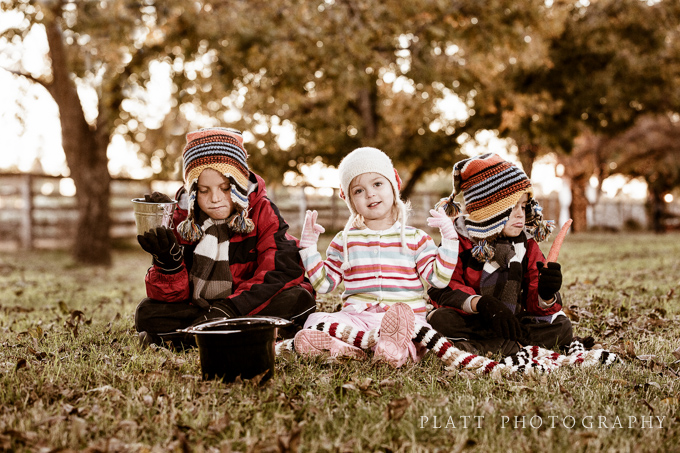 Christmas card - Children in field with no snow unable to build a snowman.