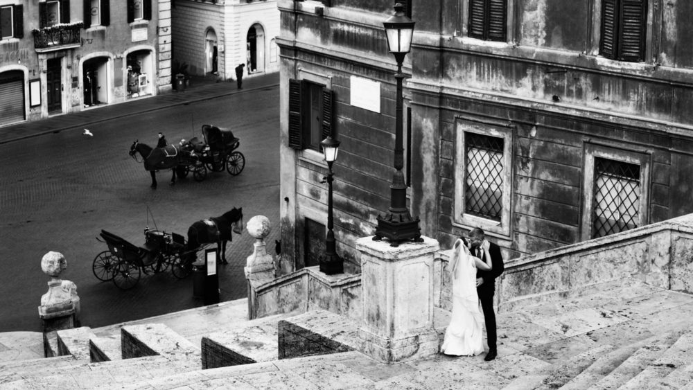 desintation wedding photograph in rome on the spanish steps with wedding couple in the foreground
