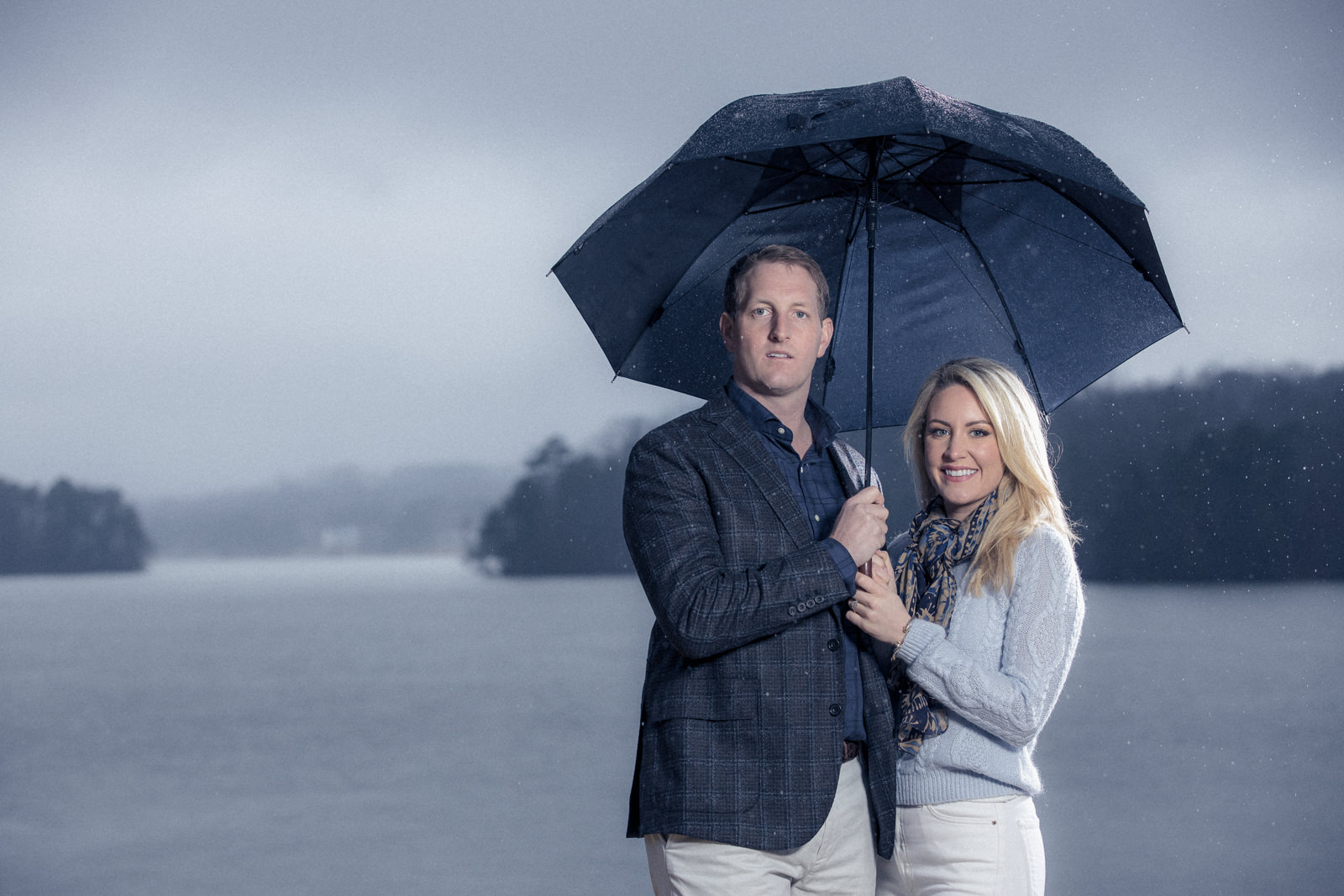 Engagement portraits in Atlanta Georgia near the lake under and umbrella
